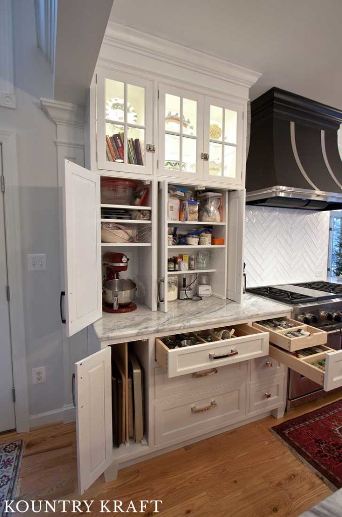 Optimal Storage Spaces were Featured in this Kitchen with Black and White Kitchen Cabinets