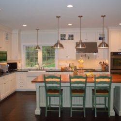 White cabinets and island with three green chairs Wyomissing, PA