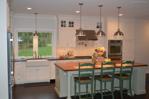 Kitchen island with three green chiars and Custom White Cabinetry Wyomissing, PA