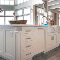 White cabinet kitchen island with built in outlet, sink, and dishwasher Lake Winnipesauke, NH