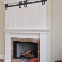 Red armchair and white dove mantel with closed TV cabinet Malvern, PA