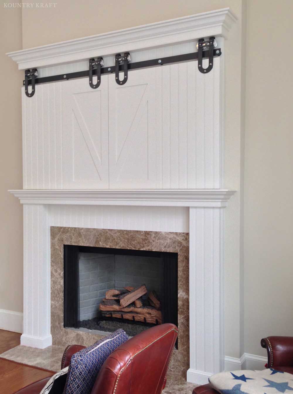 Red armchair and white dove mantel with closed TV cabinet Malvern, PA