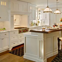 White kitchen cabinet, range, and island with seating Chatham, NJ