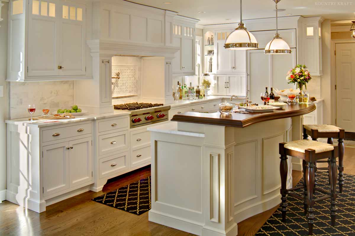 White kitchen cabinet, range, and island with seating Chatham, NJ