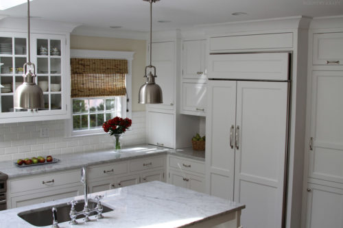 White kitchen cabinets and island with built in sink Bethesda, MD