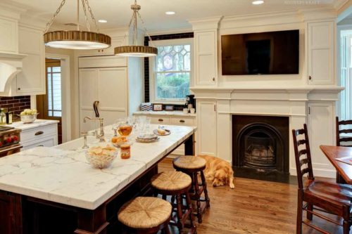 Fireplace cabinet surround and white kitchen cabinets, island, and TV Millburn, NJ