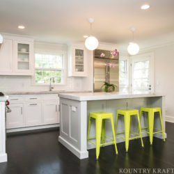 White kitchen cabinets with counter and yellow stools Summit, NJ