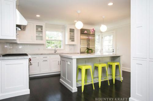 White kitchen cabinets with counter and yellow stools Summit, NJ