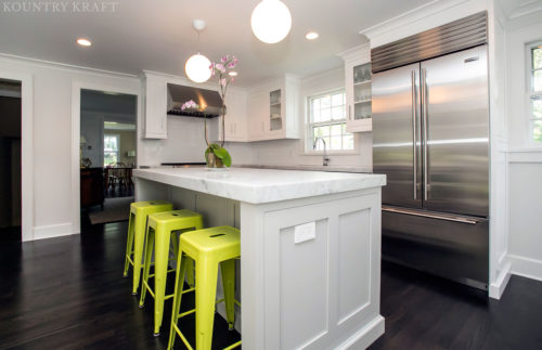 White kitchen cabinets with counter, yellow stools, and refrigerator Summit, NJ