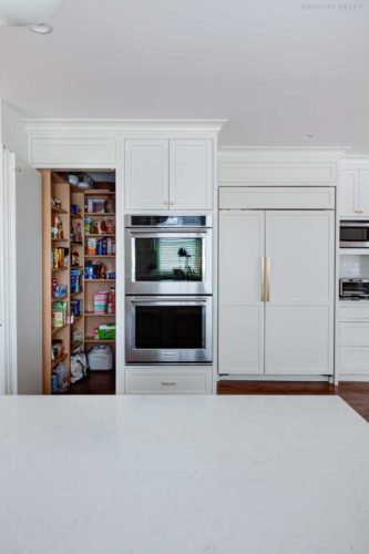 White kitchen with ovens next to a open pantry Short Hills, NJ