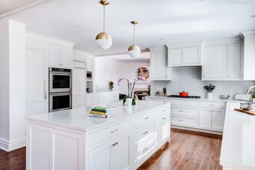 White kitchen with cabinets, ovens, and an island Short Hills, NJ