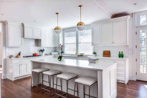 Island with four stools in a kitchen with white cabinets Short Hills, NJ