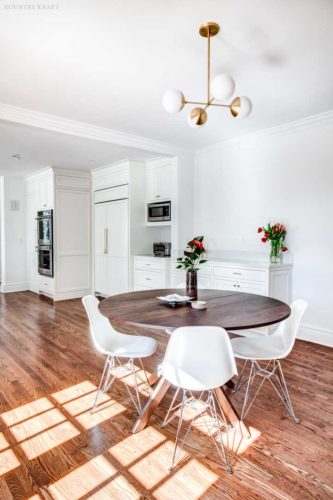 White kitchen with small round table, four chairs, and cabinetry Short Hills, NJ