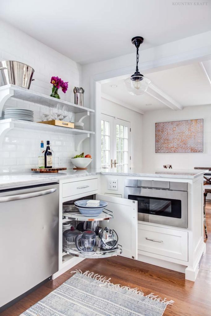 White kitchen with pull out storage shelves in a cabinet Upper Montclair, NJ