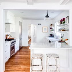 Counter, two stools, range, and refrigerator in a white kitchen Upper Montclair, NJ