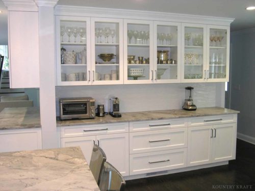 White maple kitchen with glass panel cabinets and counter Darien, CT