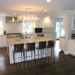 Overall view of kitchen with white maple cabinets and island Darien, CT