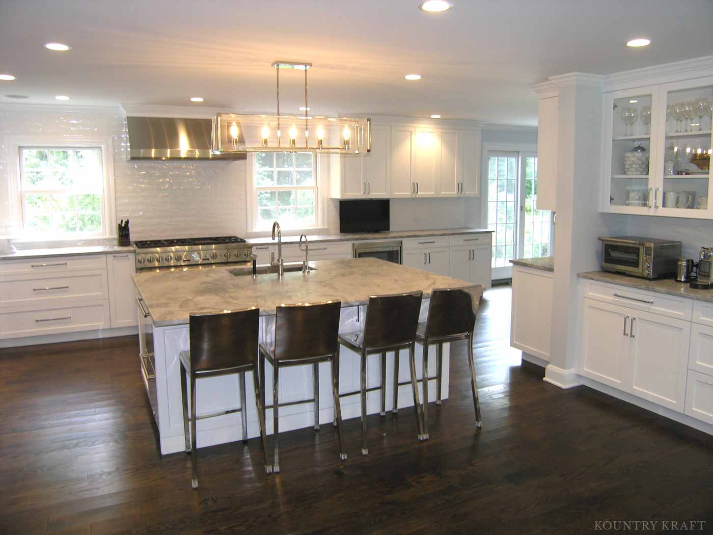 Overall view of kitchen with white maple cabinets and island Darien, CT