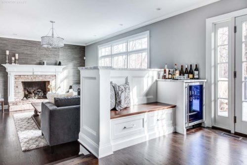 White kitchen featuring wine fridge and custom bench in Towaco, NJ