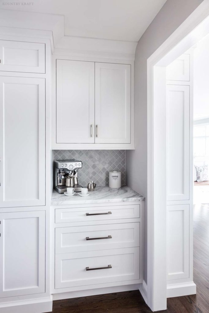 Custom white cabinetry creates a coffee station featuring a quartzite countertop in New Jersey