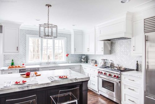 Kitchen featuring island with white quartzite countertop and white cabinetry Towaco, NJ