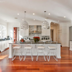 Beautiful kitchen with Brazilian cherry floors, white shaker cabinets, and island New Canaan, CT