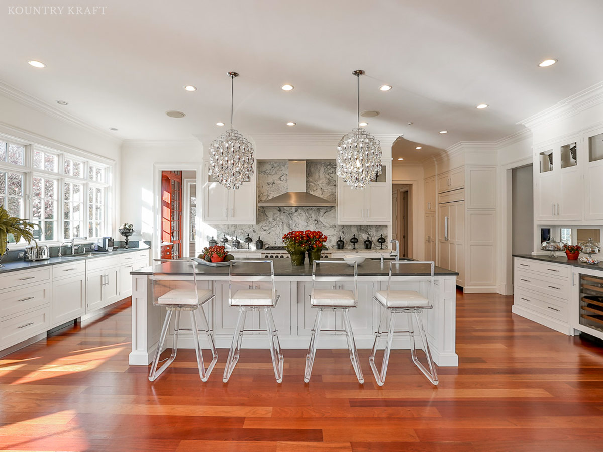 Beautiful kitchen with Brazilian cherry floors, white shaker cabinets, and island New Canaan, CT