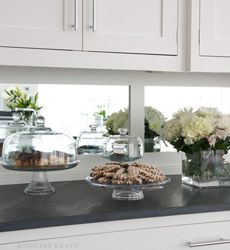 Custom white painted cabinetry and counter displaying desserts and flowers New Canaan, CT