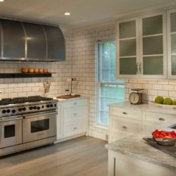 Kitchen with view of stove, counter, sink, and white storage cabinets Bryn Mawr, PA