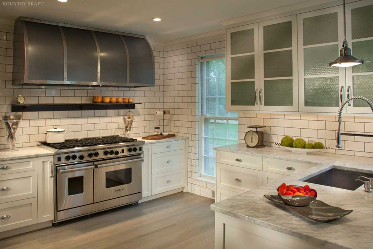 Kitchen with view of stove, counter, sink, and white storage cabinets Bryn Mawr, PA