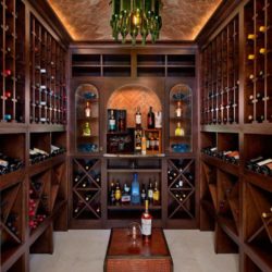 Wine room with three wine cubby walls and a wine bottle chandelier Naples, FL